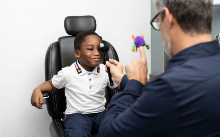 Optometrist examining a young boy